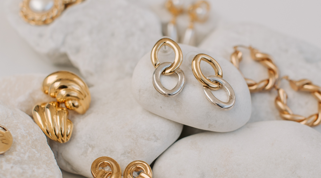 different types of earrings placed on a beautiful layout. Written by JACOBSVOW