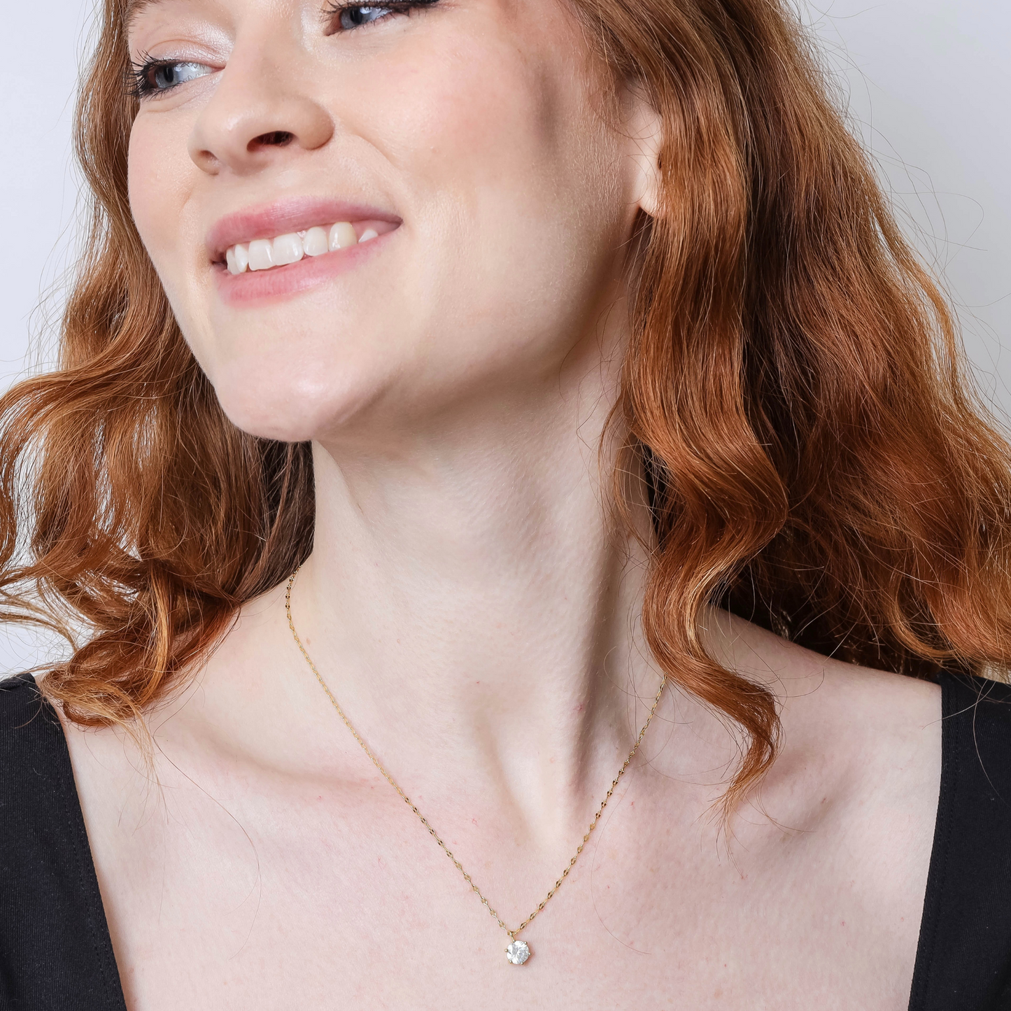 18K Gold Round-Cut Cubic Zirconia Pendant Necklace On Woman's Neck Up Close