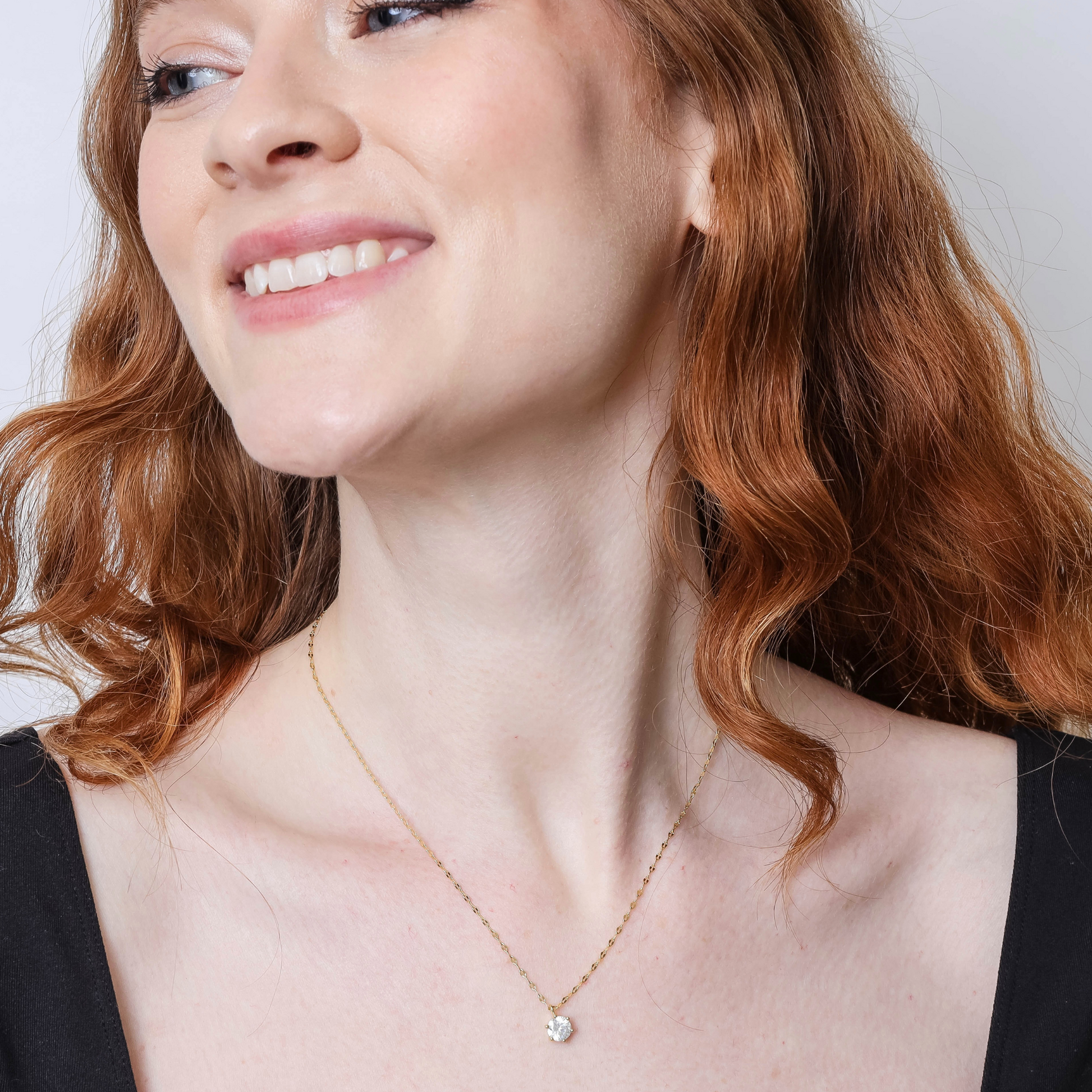 18K Gold Round-Cut Cubic Zirconia Pendant Necklace On Woman's Neck Up Close